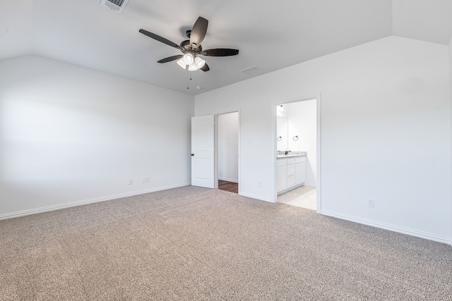 unfurnished bedroom with vaulted ceiling, visible vents, and light carpet