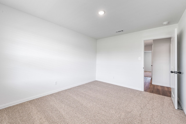 unfurnished bedroom with baseboards, dark colored carpet, visible vents, and recessed lighting