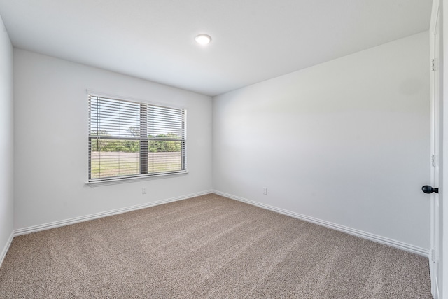 carpeted empty room featuring baseboards and recessed lighting