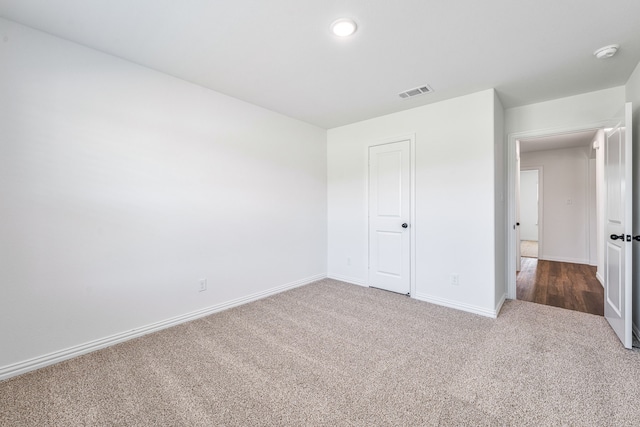 unfurnished bedroom featuring visible vents, carpet flooring, and baseboards