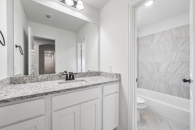 full bathroom with vanity, marble finish floor, toilet, visible vents, and bathing tub / shower combination