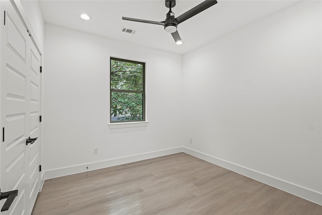 empty room featuring ceiling fan and light hardwood / wood-style flooring