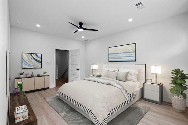 bedroom with light hardwood / wood-style floors and ceiling fan