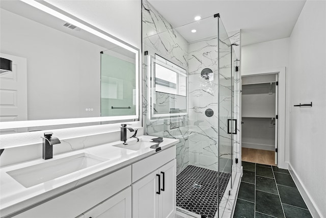 bathroom featuring vanity, tile patterned floors, and a shower with shower door