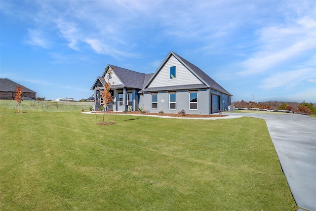 view of front of home featuring a garage and a front lawn