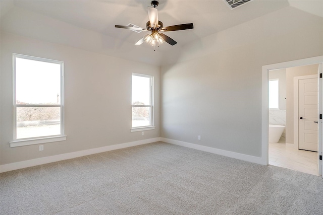 carpeted spare room featuring ceiling fan