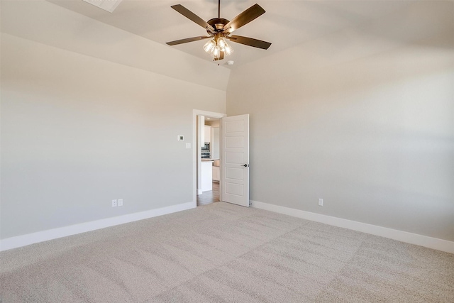 carpeted spare room with a towering ceiling and ceiling fan