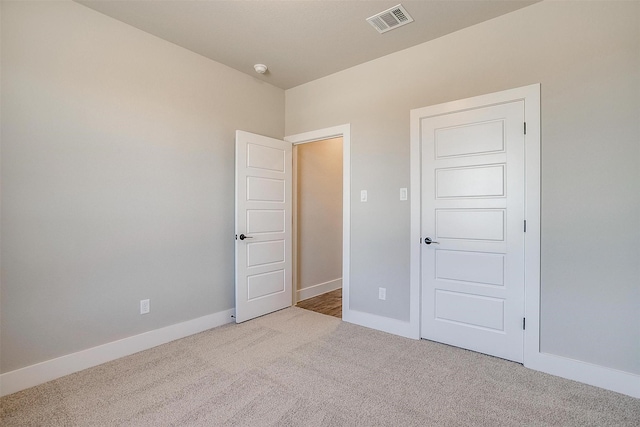 unfurnished bedroom with light carpet