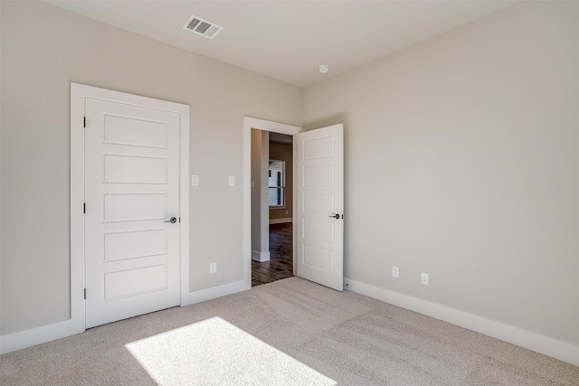 unfurnished bedroom featuring light colored carpet