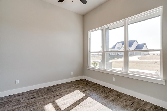 unfurnished room with ceiling fan and dark wood-type flooring