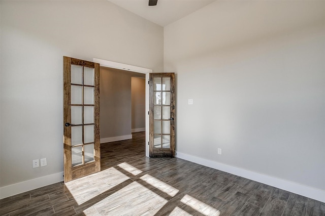 empty room featuring french doors and dark hardwood / wood-style floors