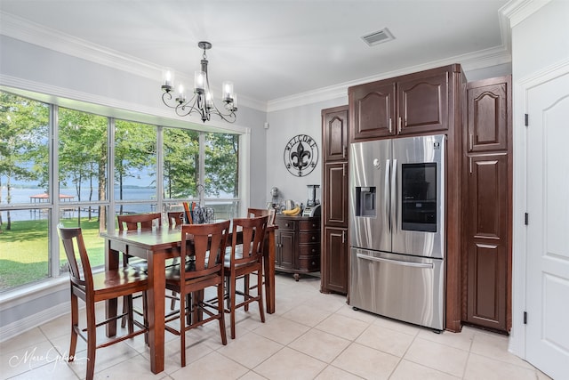 tiled dining area with a chandelier, a healthy amount of sunlight, and ornamental molding