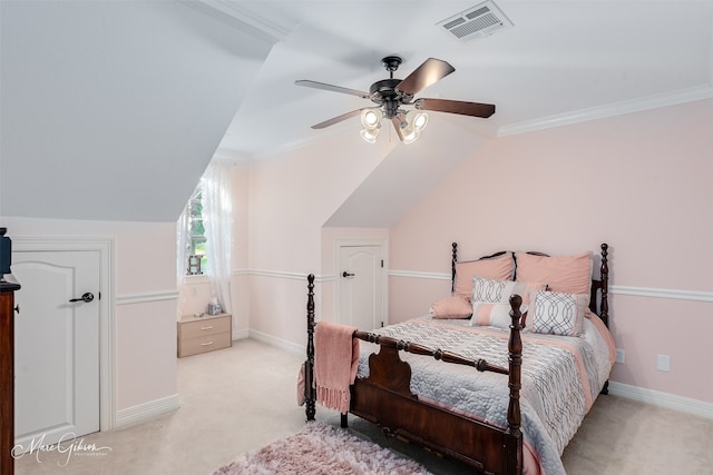 carpeted bedroom featuring ornamental molding, vaulted ceiling, and ceiling fan