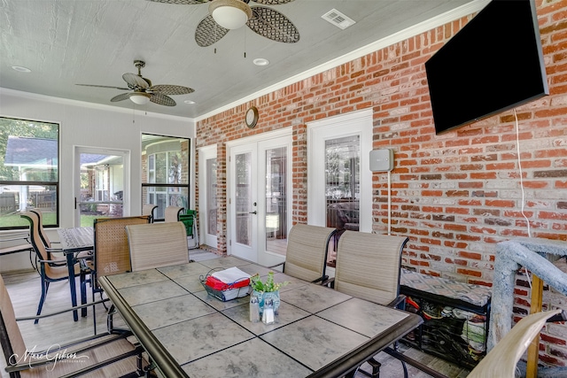 sunroom featuring ceiling fan