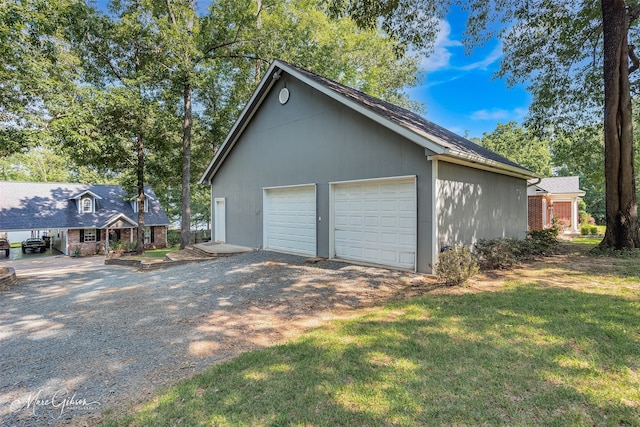 garage featuring a lawn