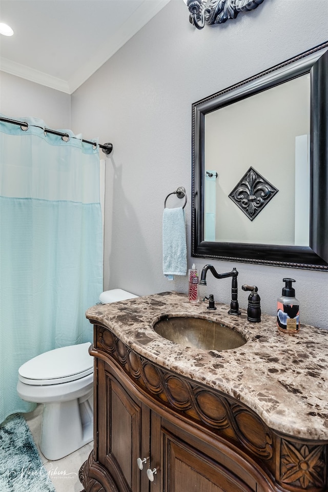 bathroom with toilet, vanity, tile patterned floors, and crown molding