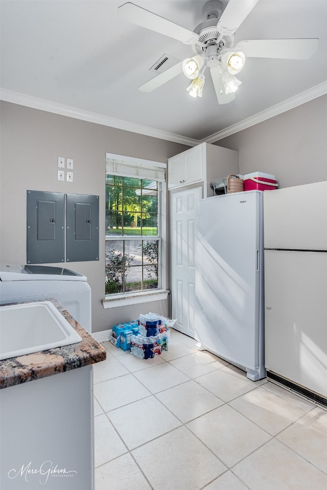 kitchen with white cabinetry, light tile patterned floors, and crown molding