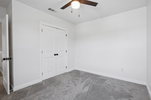 unfurnished bedroom with a closet, ceiling fan, and carpet floors