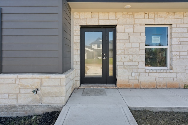 view of exterior entry featuring french doors