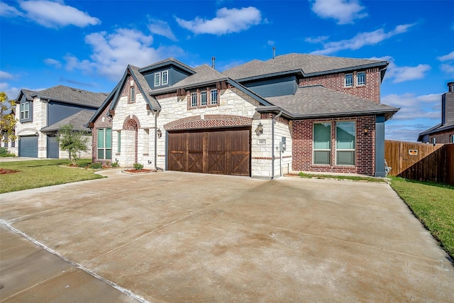 view of front of property featuring a garage, fence, stone siding, concrete driveway, and roof with shingles