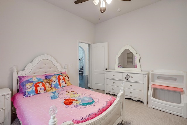 bedroom with a ceiling fan and light carpet