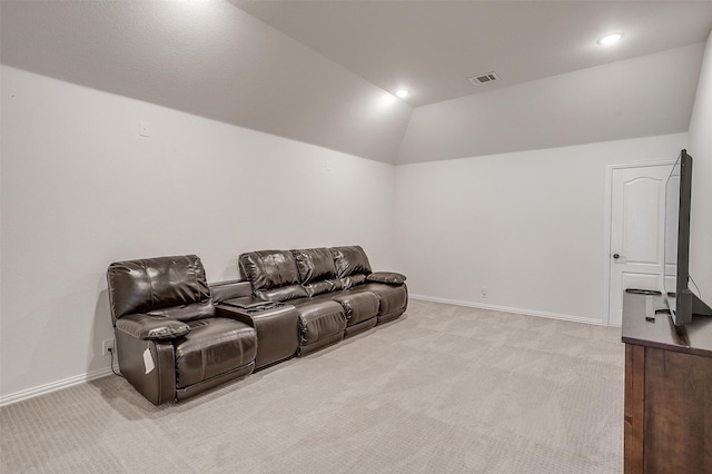 home theater featuring light colored carpet and lofted ceiling