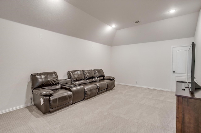 home theater with lofted ceiling, baseboards, visible vents, and light colored carpet