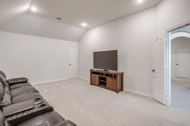 living room with light colored carpet, vaulted ceiling, visible vents, and baseboards