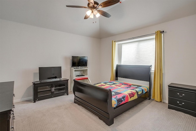 bedroom with a ceiling fan, lofted ceiling, light colored carpet, and baseboards