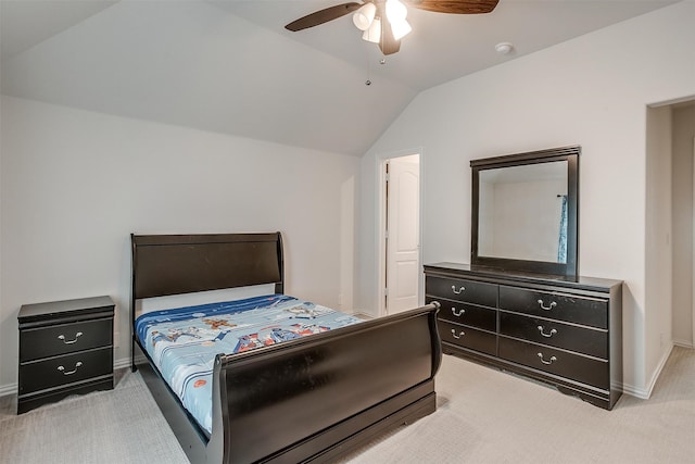 bedroom with ceiling fan, light carpet, and vaulted ceiling