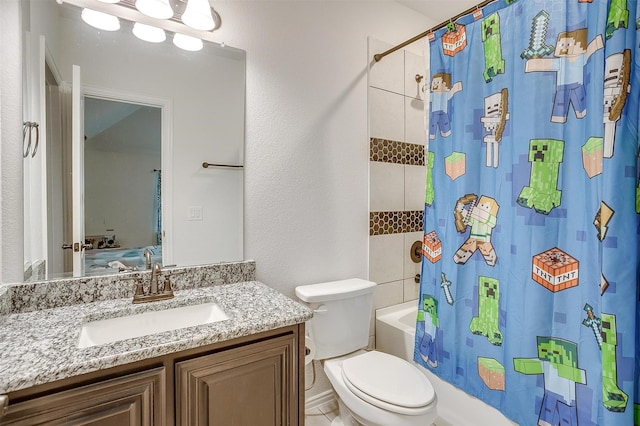 bathroom with shower / tub combo, a textured wall, vanity, and toilet