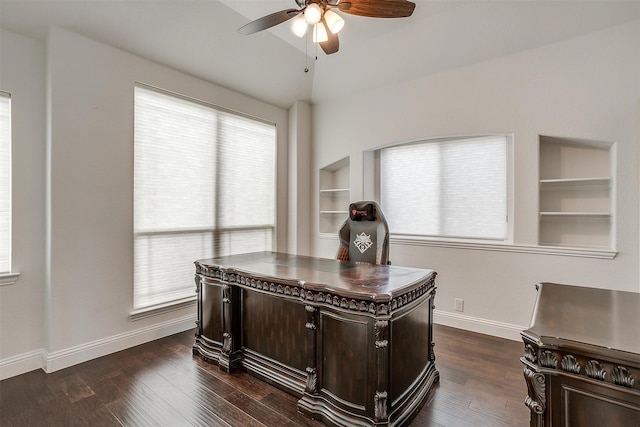 office with built in shelves, ceiling fan, vaulted ceiling, and a wealth of natural light