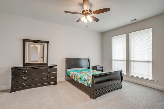 bedroom featuring ceiling fan and light carpet