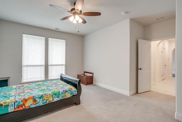 bedroom with ceiling fan and light carpet