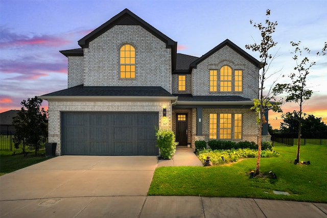 view of front of house featuring a lawn and a garage