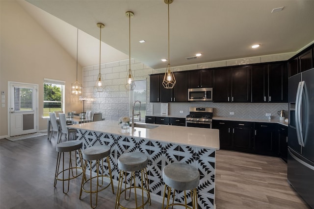 317 St Paul Ct, Heath, TX 75126 - kitchen featuring stainless steel appliances, a sink, healthy amount of natural light, light wood-type flooring, and recessed lighting