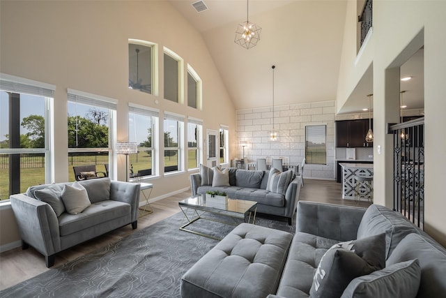317 St Paul Ct, Heath, TX 75126 - living area with high vaulted ceiling, wood finished floors, baseboards, and a chandelier