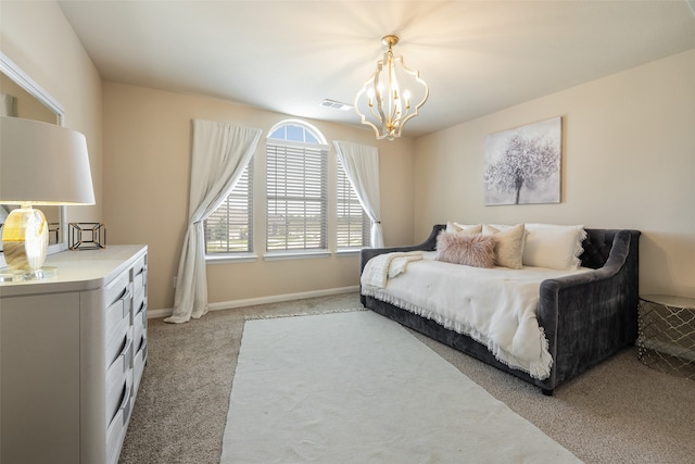 carpeted bedroom featuring an inviting chandelier