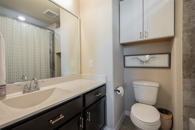 bathroom featuring toilet, vanity, and walk in shower