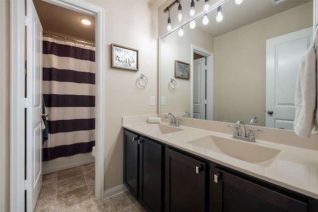 bathroom with curtained shower, tile patterned floors, vanity, and toilet