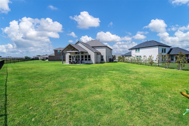 back of property with a patio area and a lawn