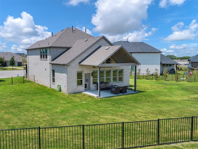 back of house with a patio and a yard