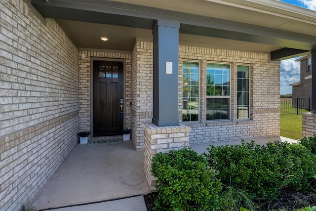 317 St Paul Ct, Heath, TX 75126 - doorway to property featuring covered porch, brick siding, and fence