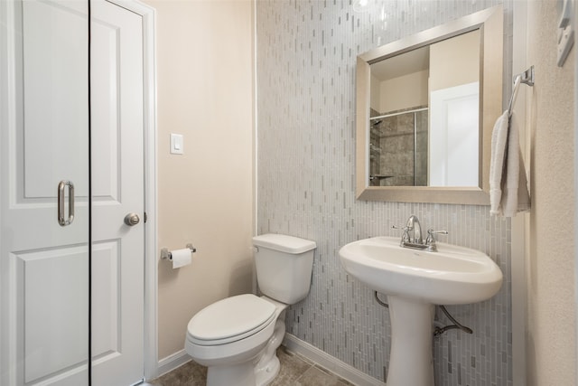 bathroom with tile patterned flooring, sink, and toilet