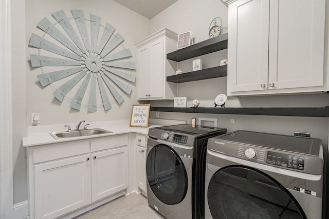 laundry area with cabinets, washing machine and dryer, light tile patterned flooring, and sink