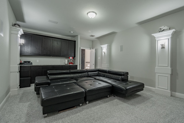 carpeted home theater room featuring ornate columns