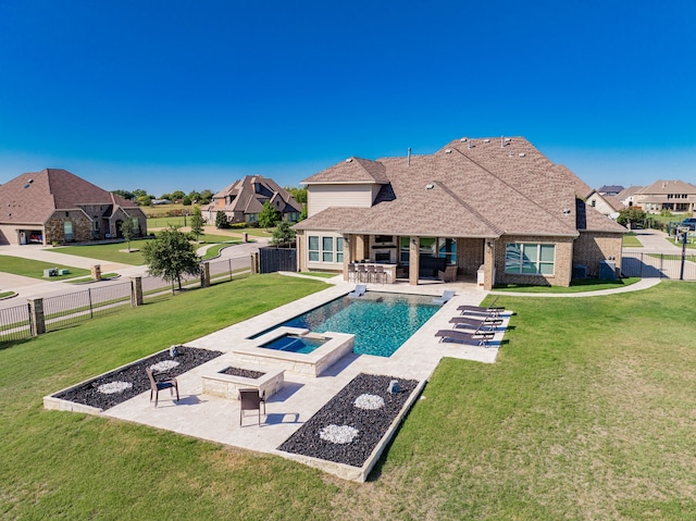 view of swimming pool featuring an in ground hot tub, an outdoor living space with a fire pit, a patio area, and a lawn