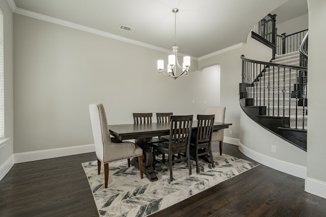 dining area with an inviting chandelier, dark hardwood / wood-style floors, and ornamental molding