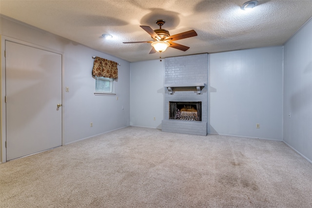 unfurnished living room with a brick fireplace, light colored carpet, a textured ceiling, and ceiling fan