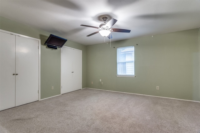 unfurnished bedroom with ceiling fan and light colored carpet